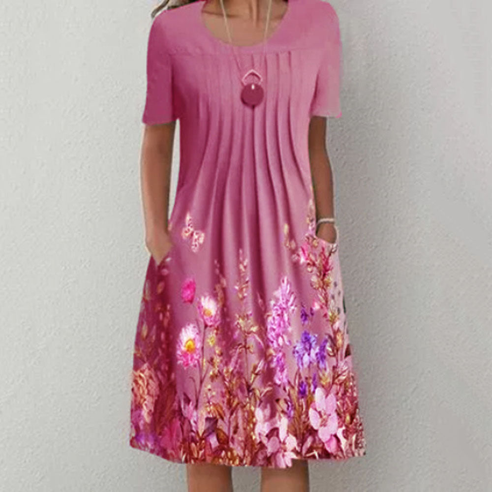 Damen Plissee Midi Kleid mit kurzen Ärmeln, seitlichen Taschen und floralem Saum – Élara