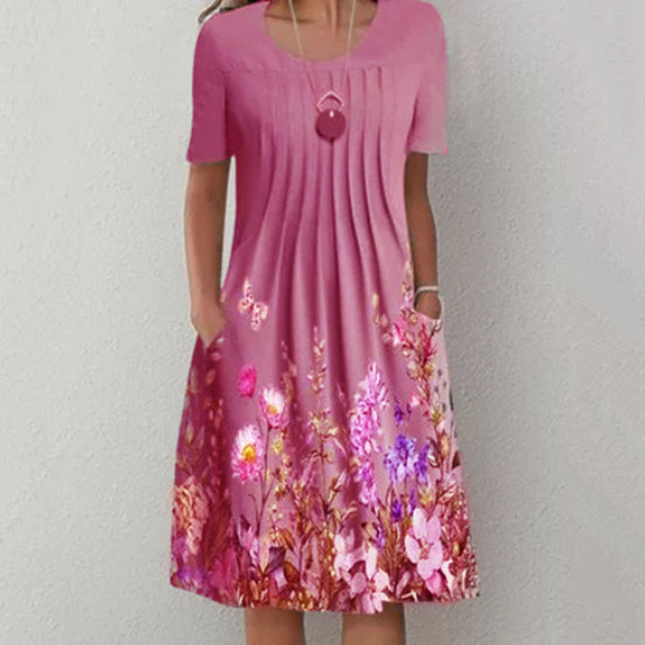 Damen Plissee Midi Kleid mit kurzen Ärmeln, seitlichen Taschen und floralem Saum – Élara
