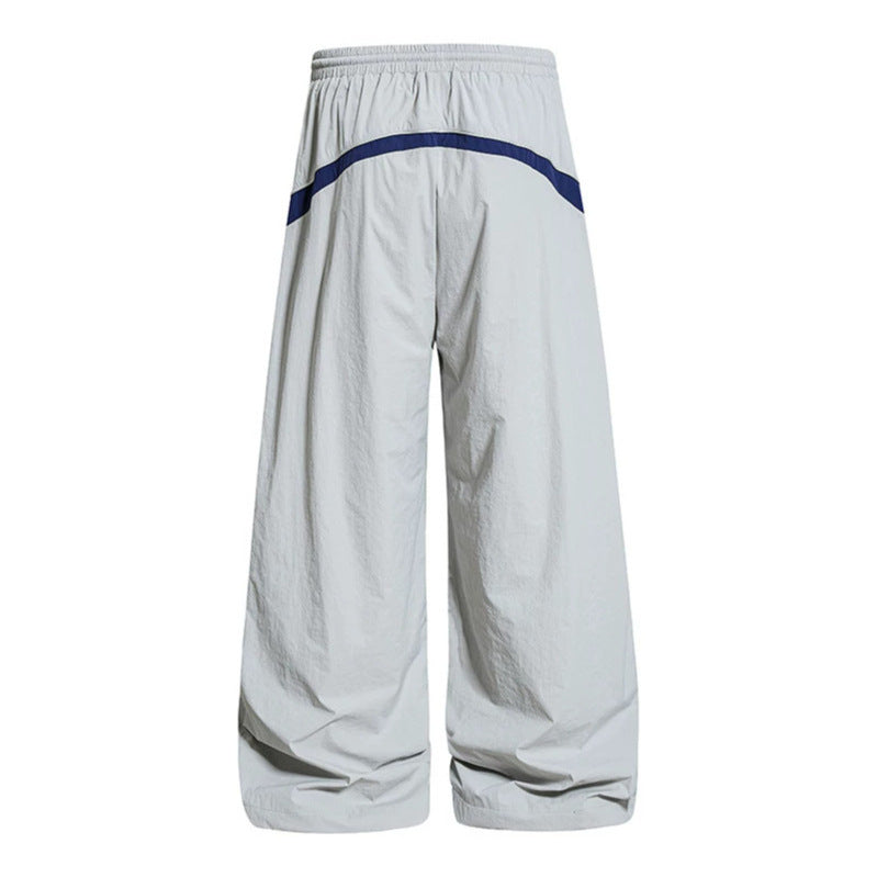Damen Weite Nylon-Palazzo-Trainingshose mit Tunnelzug, seitlichen Kontrastdreiecken und verstellbarem Saum Echoarchiv
