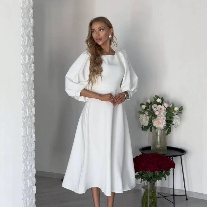 Damen Midikleid mit offenem Rückenausschnitt, voluminösen Puffärmeln und Bindegürtel Echoarchiv