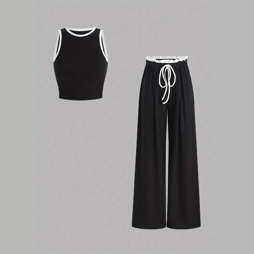 Damen stylishes Sport-Set mit hoch taillierter Weitbein-Hose und sportlichem Bustier Echo Archiv