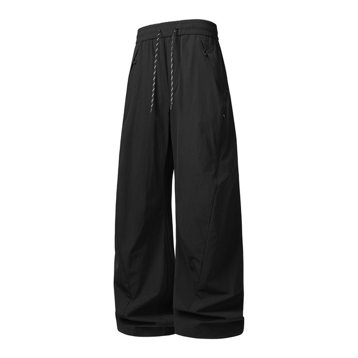 Unisex Weite Tech-Baggy-Hose mit elastischem Kordbund, Reißverschlusstaschen & wasserabweisender Nylonoptik Echoarchiv