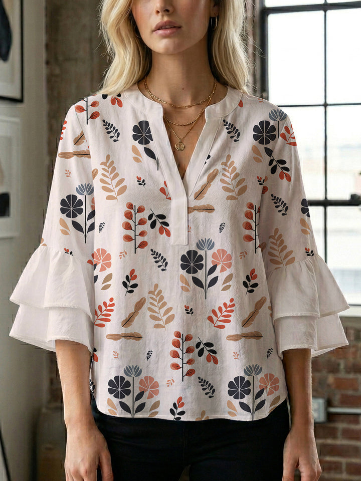 Damen Bluse mit voluminösen Rüschenärmeln und modernem Motiv Echo Archiv